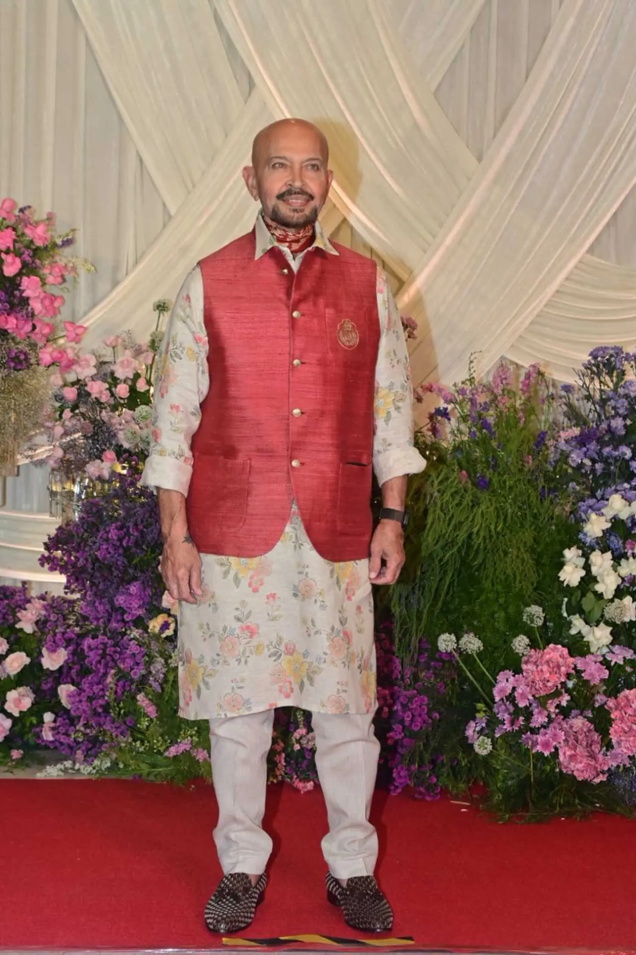 <p>Filmmaker Rakesh Roshan attended the festivities in vibrant ethnic wear. He opted for floral kurta with red jacket over it and white pants.</p>